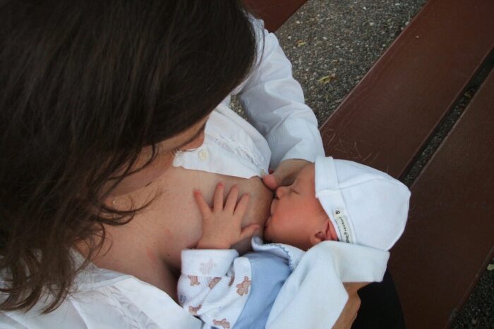 A woman breastfeeding a newborn baby