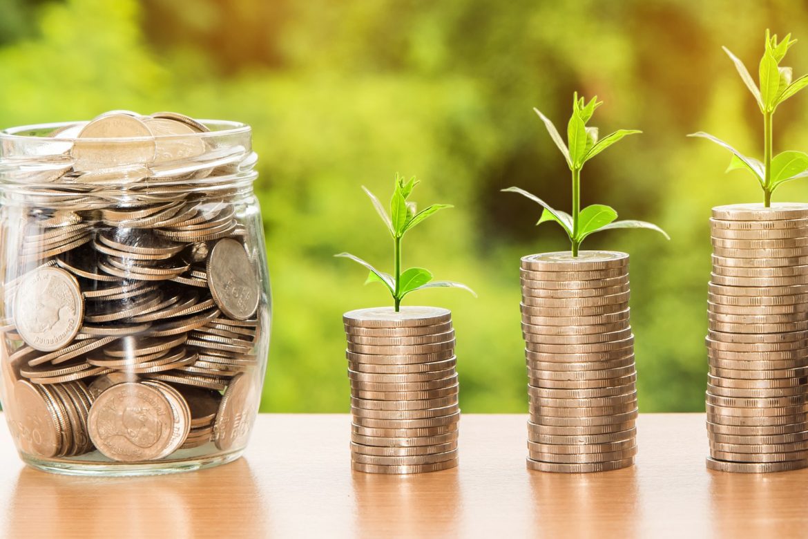 A jar of coins, followed by 2 stacks of coins increasing in size