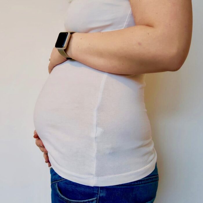 A pregnant woman with a white tshirt on