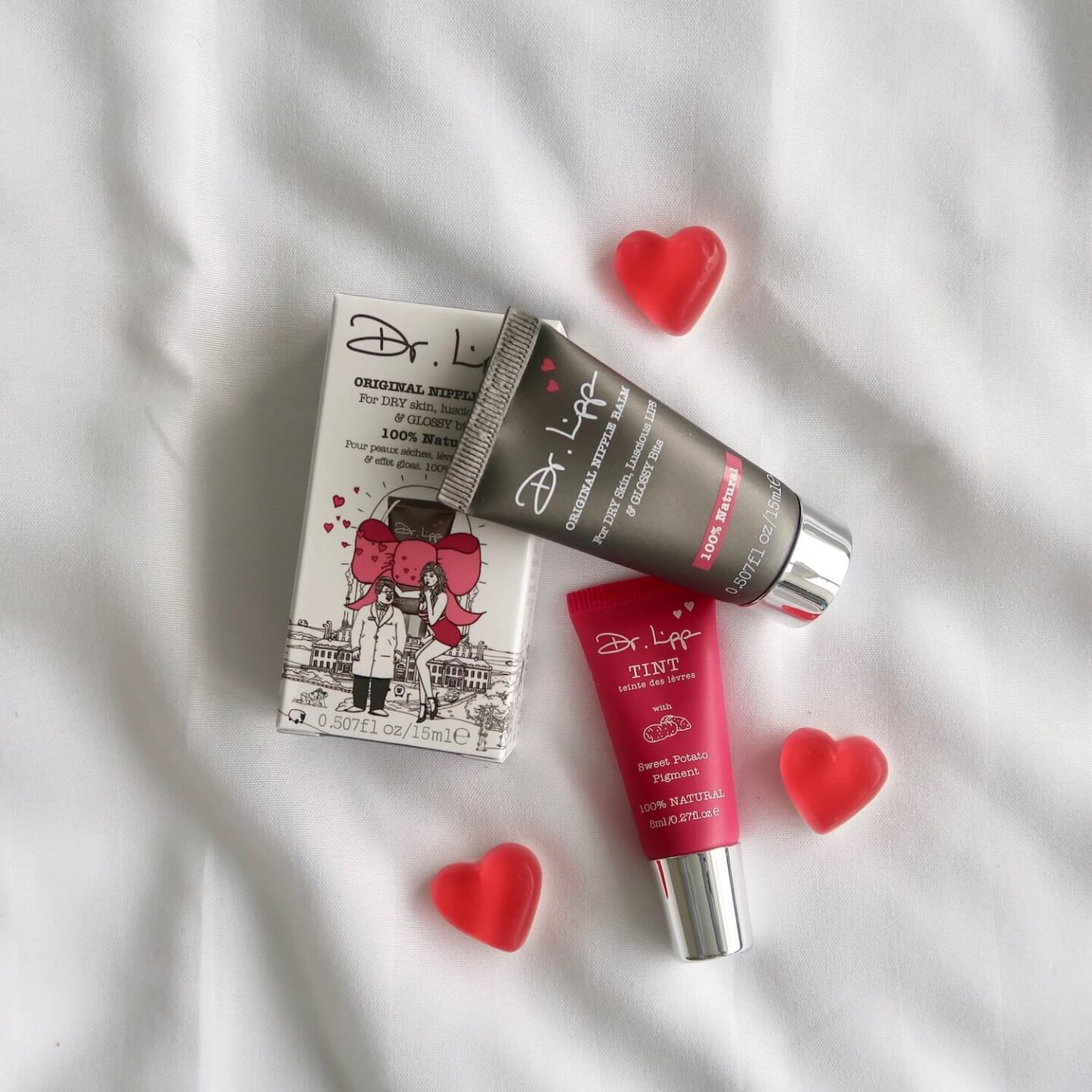 2 Dr Lipp lip balm tubes with 3 love heart sweets around it