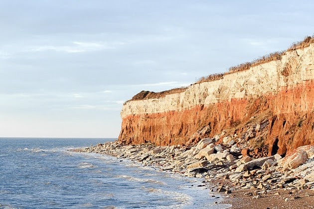 Things To Do In Norfolk: Hunstanton Beach. The sea with orange cliffs