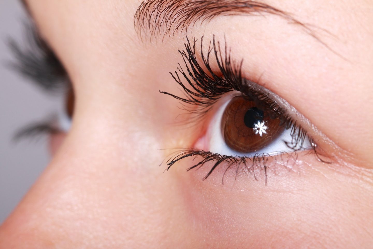 A woman's eye close up. Her eyes are brown and she is wearing mascara