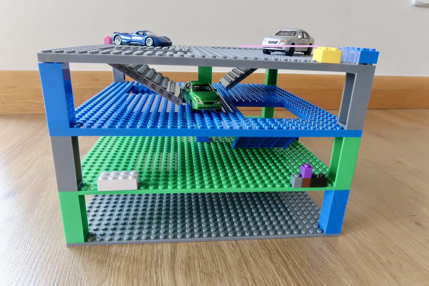 A tower made up of Strictly Briks, similar to LEGO, with ramps and gaps and toy cars. Made to look like a car garage