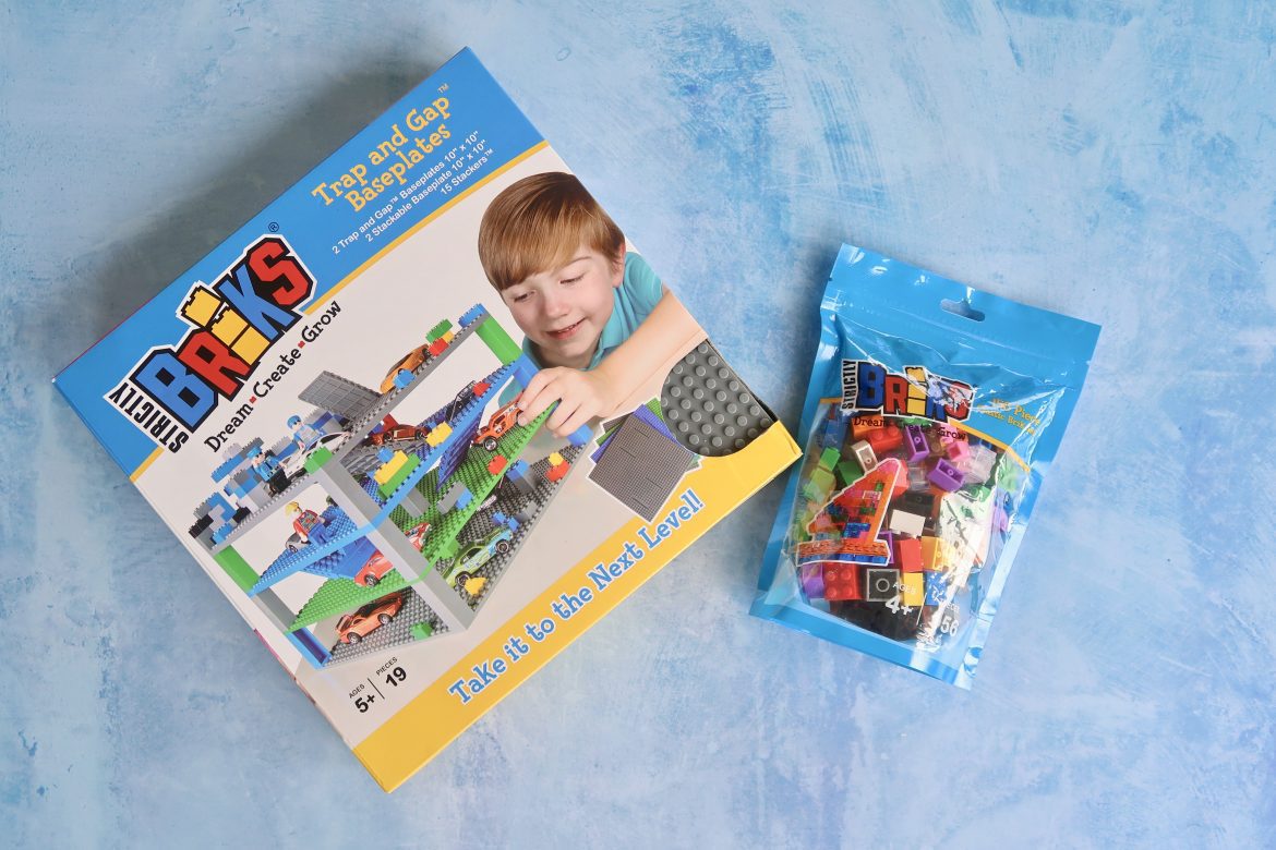 A box of Strictly Briks base plates and stackers, and a bag of bricks
