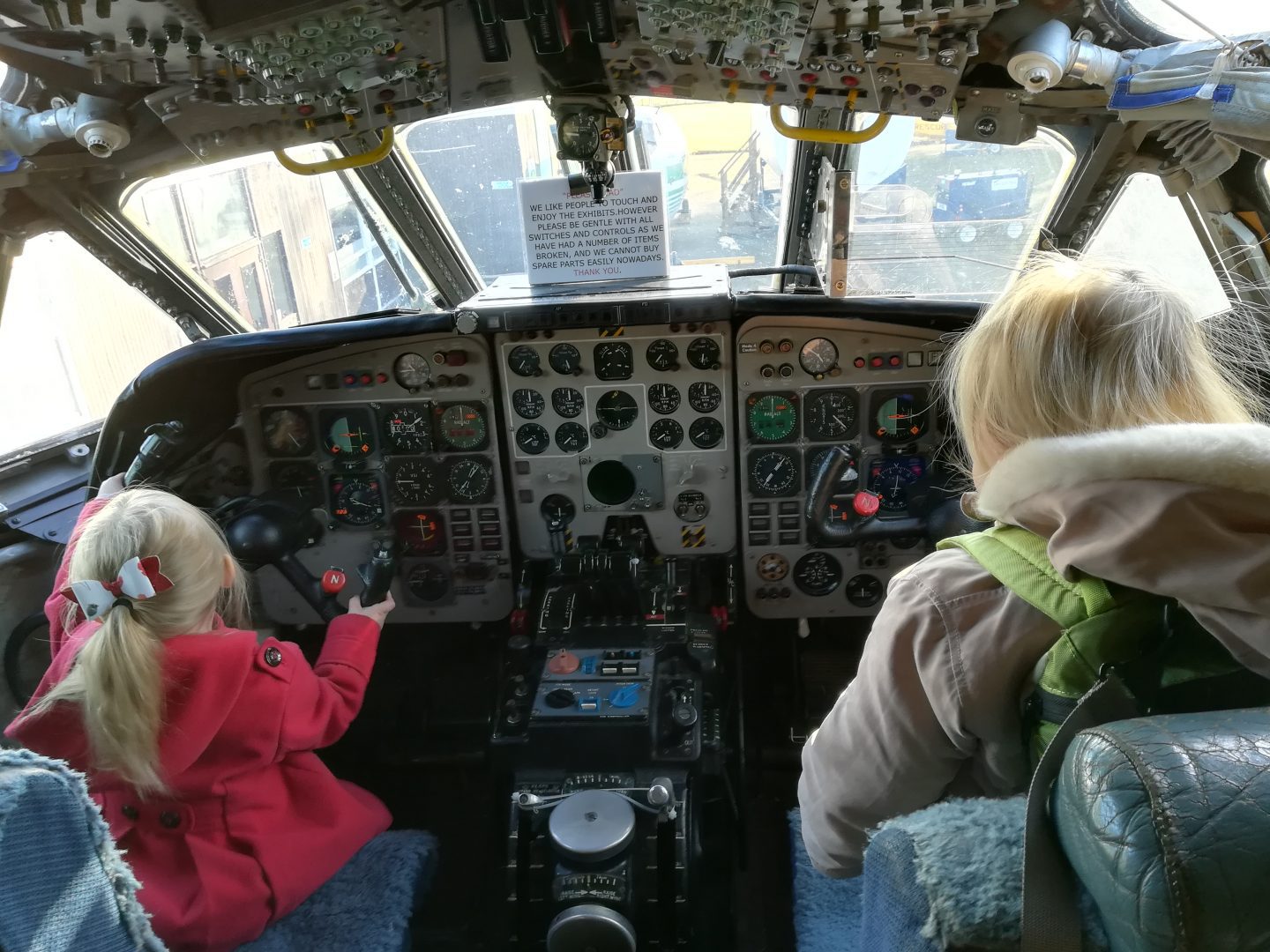 Children sitting in the cockpit of a plane in an aircraft museum in Morayvia