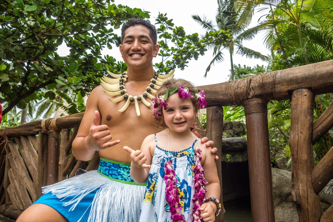 A young girl and a man at a Polynesian Cultural Center in Oahu Hawaii