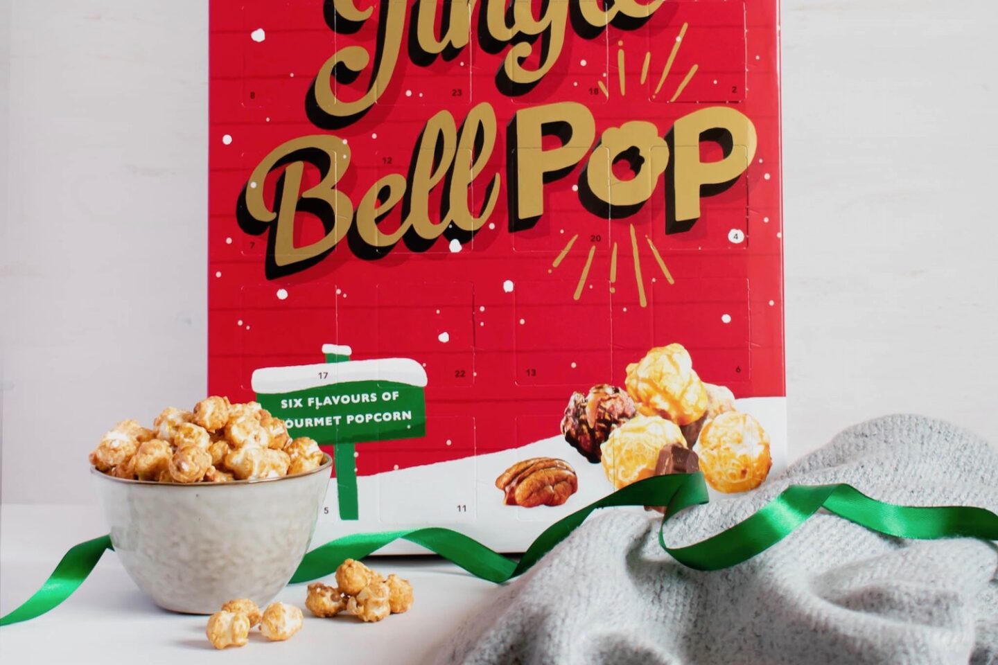 A bowl of popcorn in front of a popcorn advent calendar