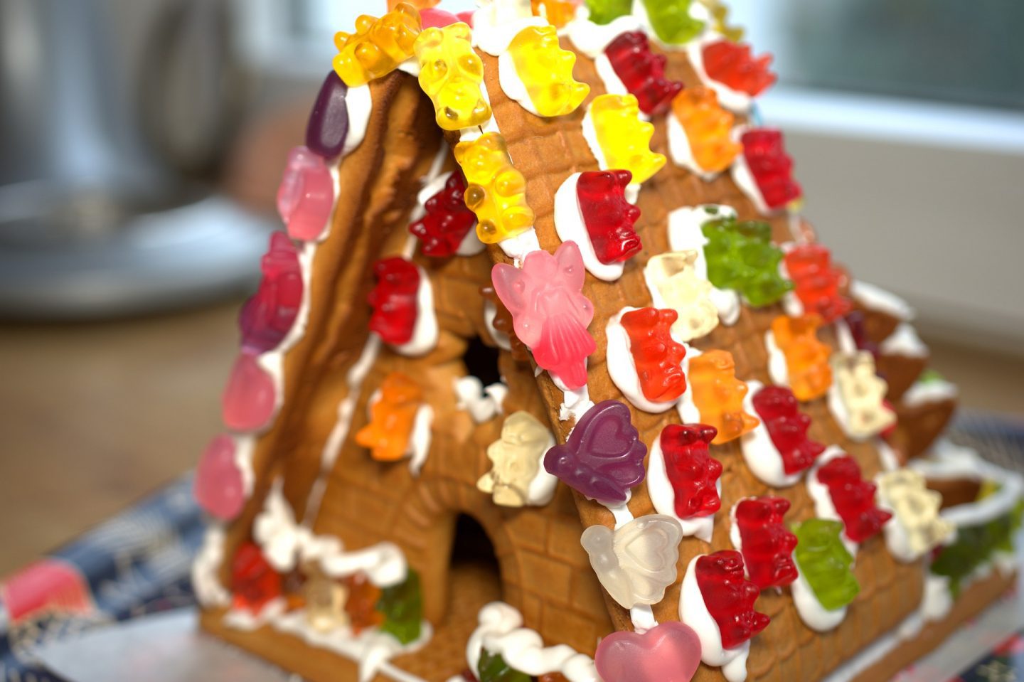 A gingerbread house covered in gummy sweets