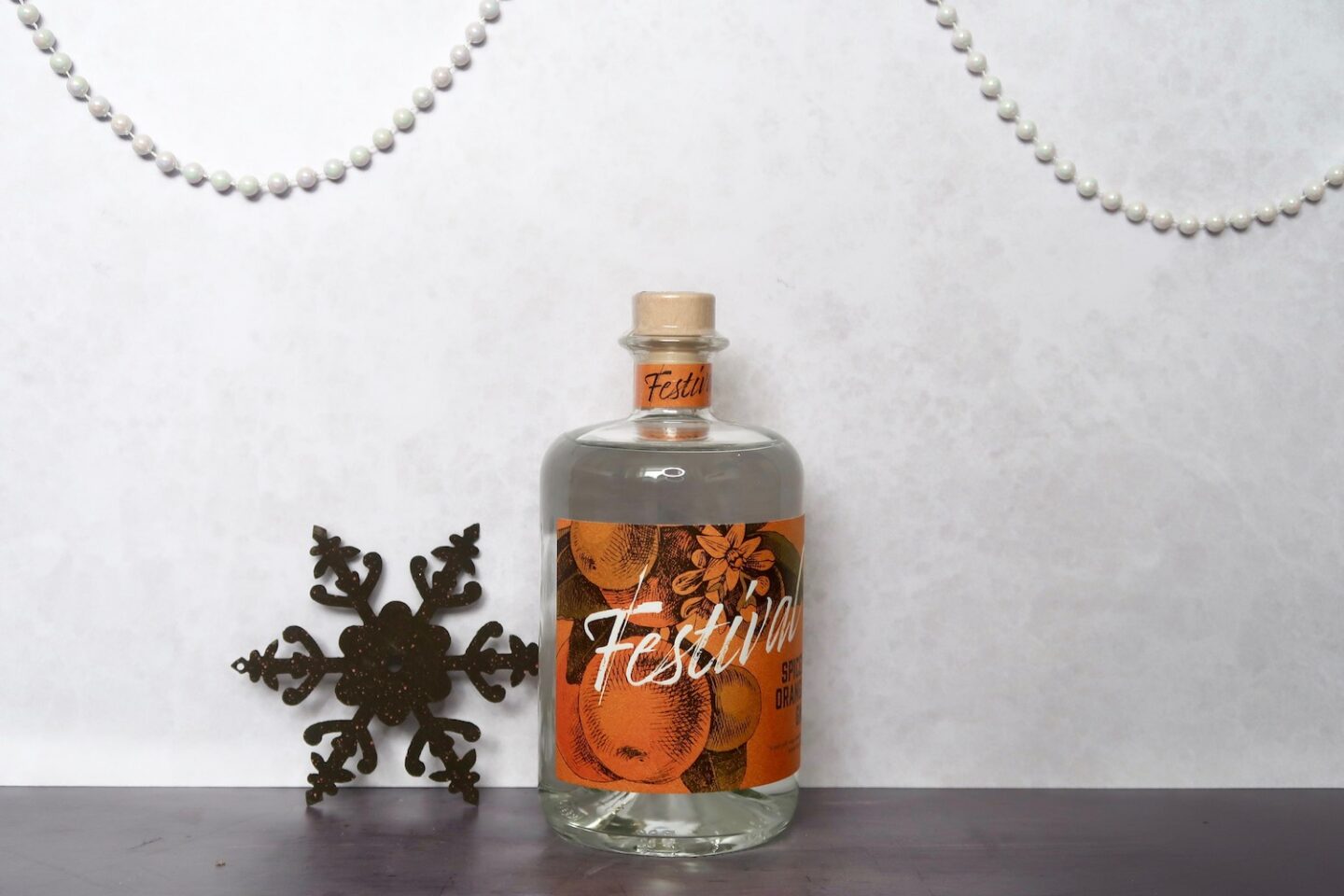 A bottle of gin with an orange label, with Festival Spiced Orange written on it.