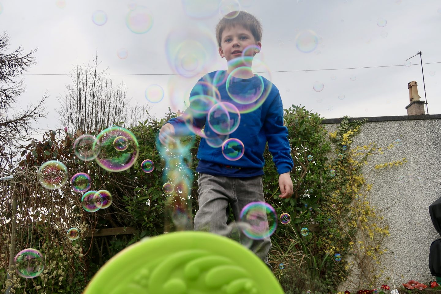 A bubble machine with bubbles coming out of the top