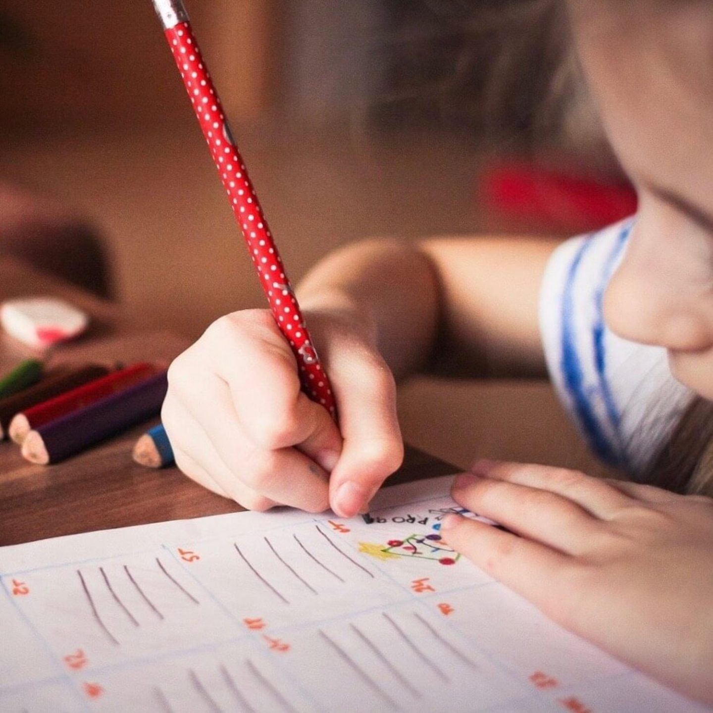 A child writing on a piece of paper