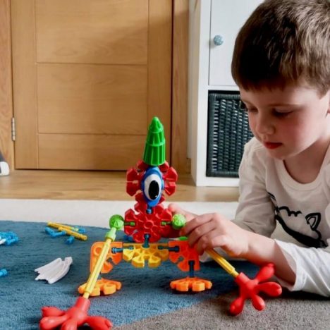 A boy playing with Kid K'Nex