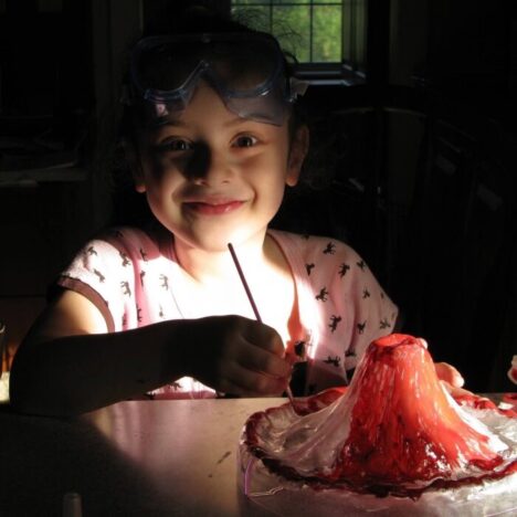 A child painting a model volcano