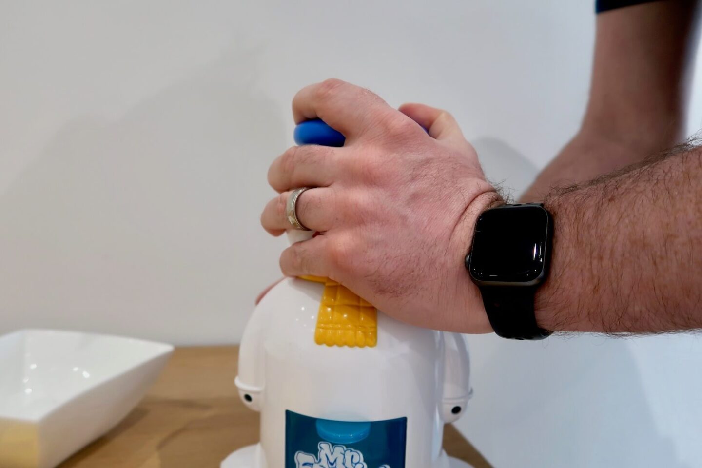 A hand holding the top of a Mr Frosty Ice Crunchie Maker