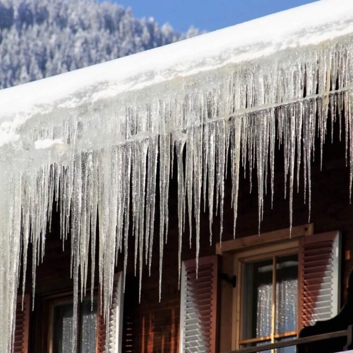 A building with snow and icicles on the roof