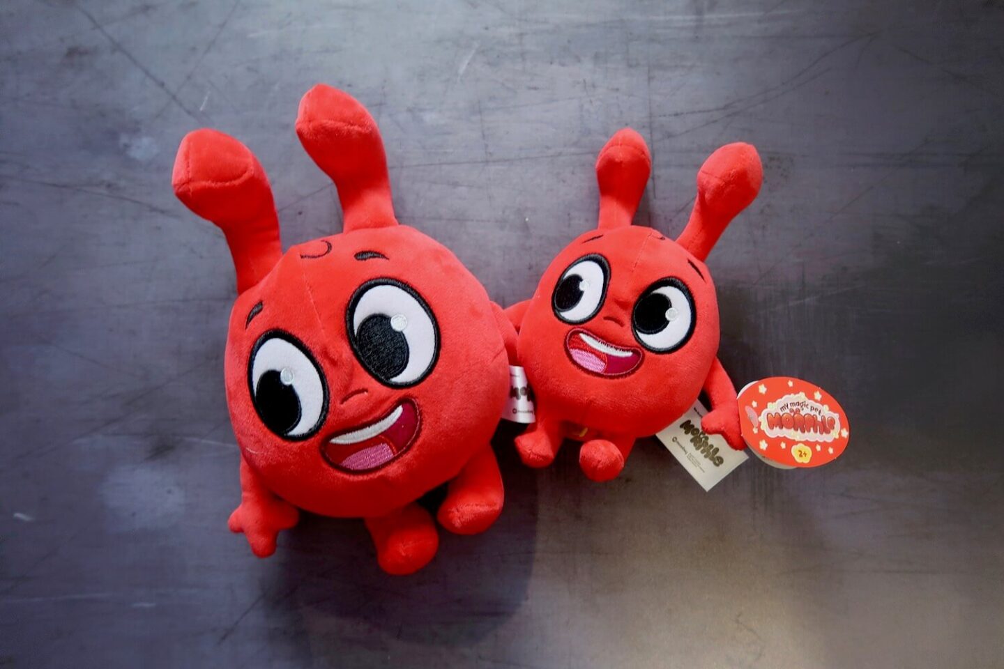 Two red Morphle stuffed toys