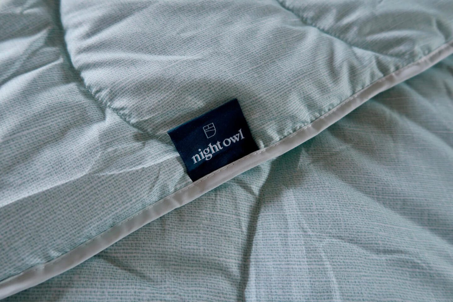 The label of a Night Owl coverless duvet in Aurora Green