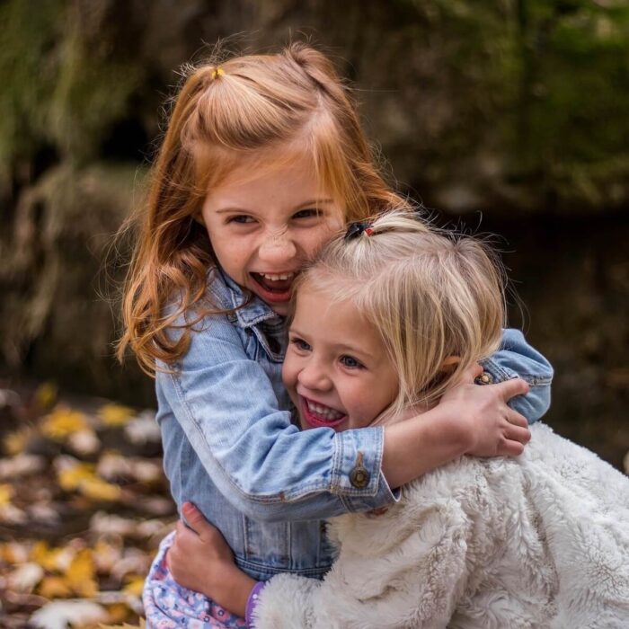 two young girls hugging each other