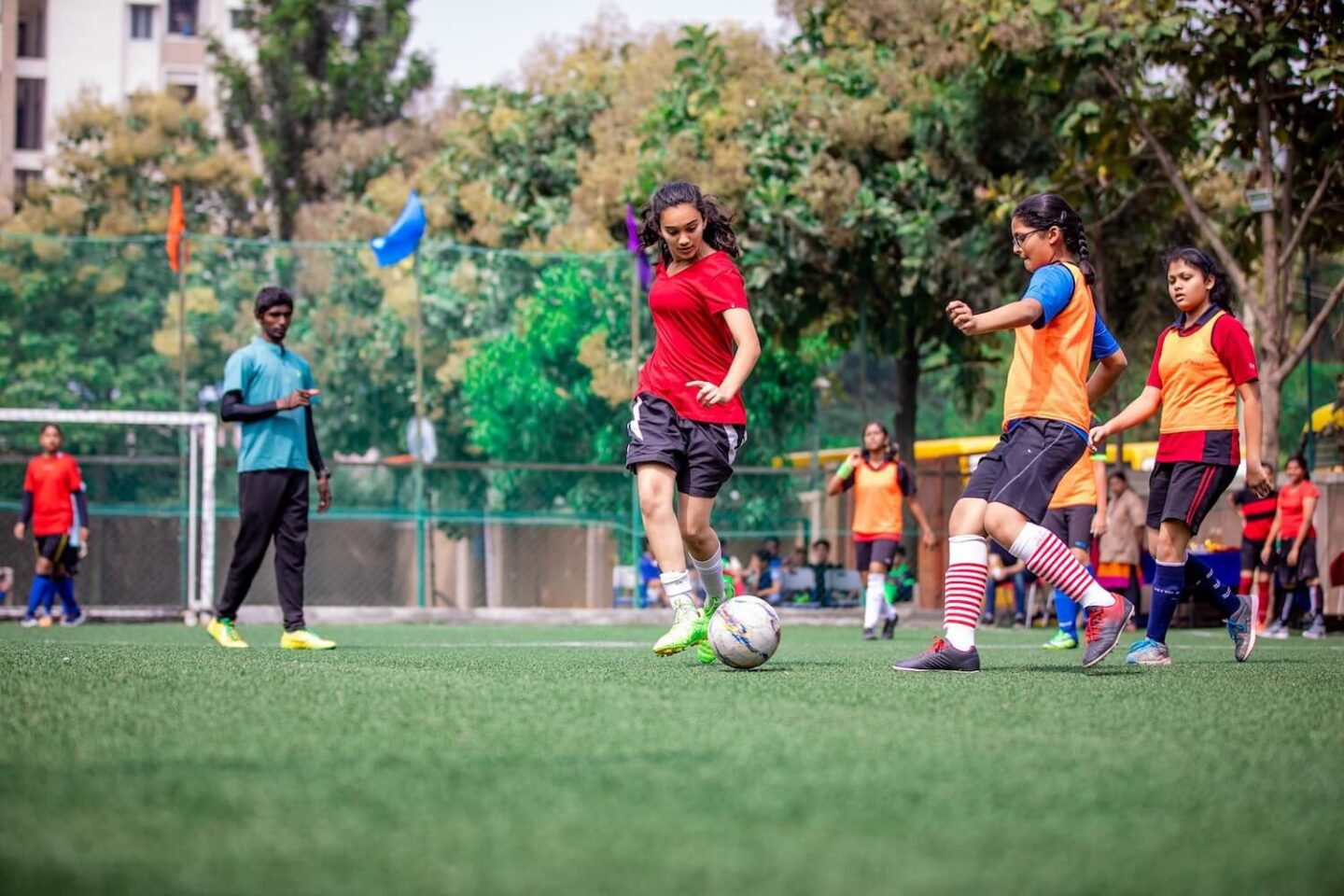 A group of girls playing football outside