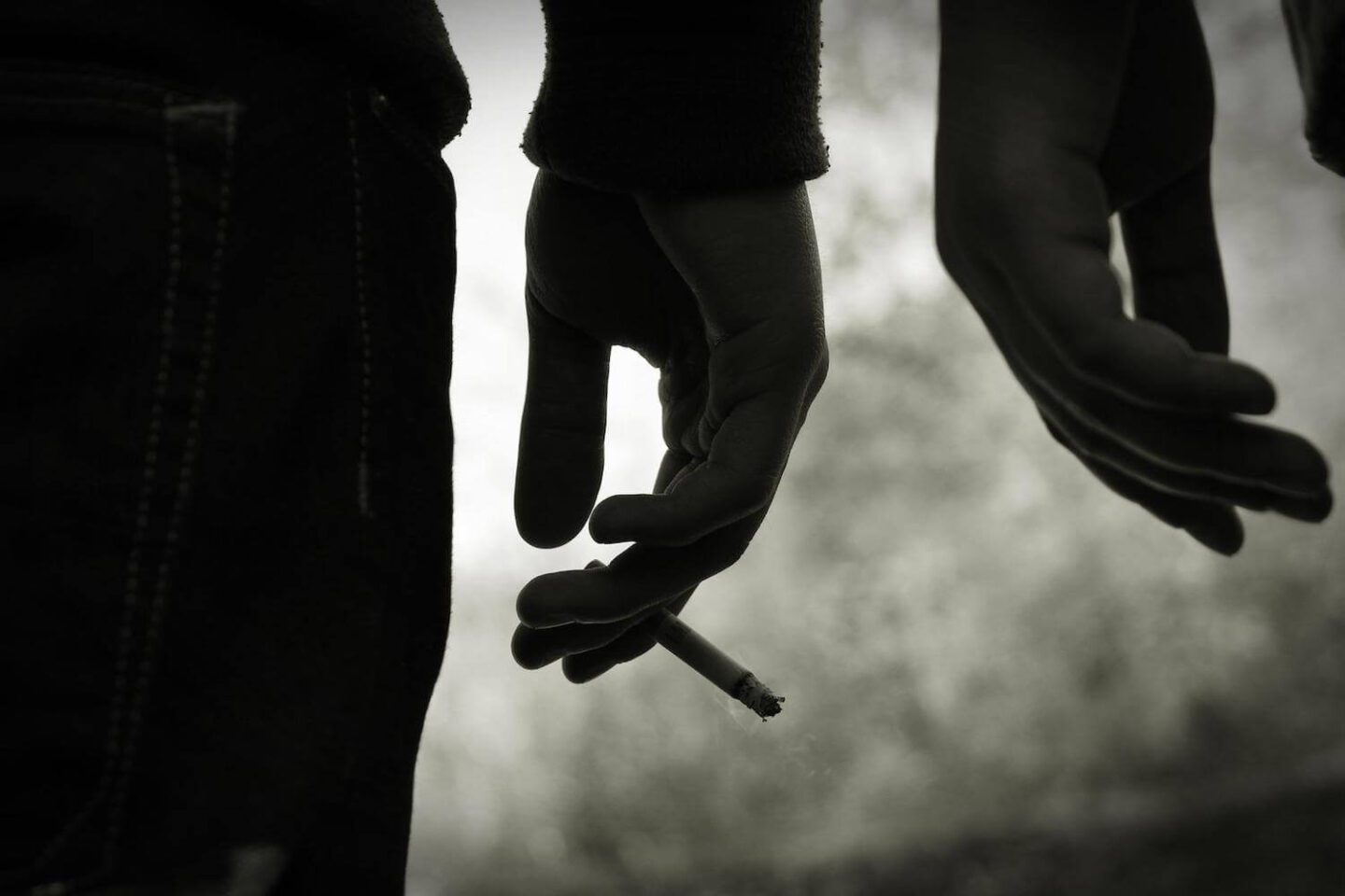 a hand holding a cigarette