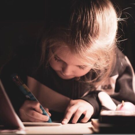 A girl writing in an open notebook