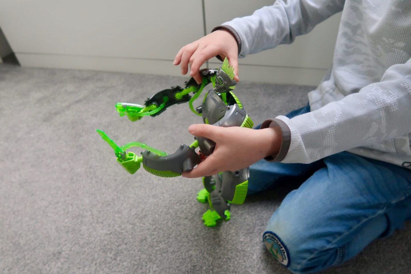 The arms of a child playing with a Gigabot toy