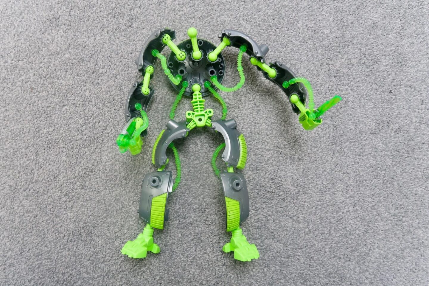 A Gigabot partially built. It is lying on a grey carpet