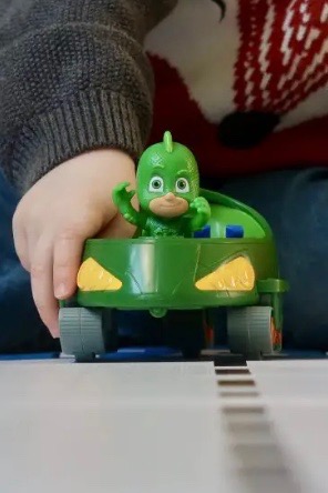 A green toy car with Gecko from PJ masks