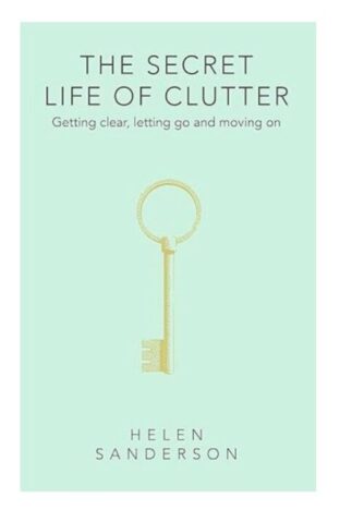 A mint green front cover of a book. It has a picture of a gold key on it and the title is "The secret life of clutter"
