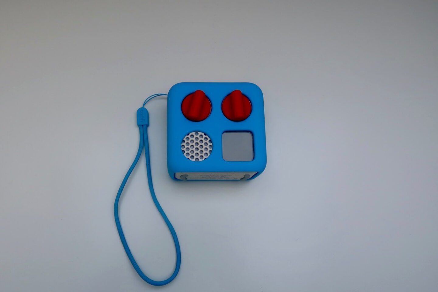 A yoto mini with a blue adventure jacket and wrist strap