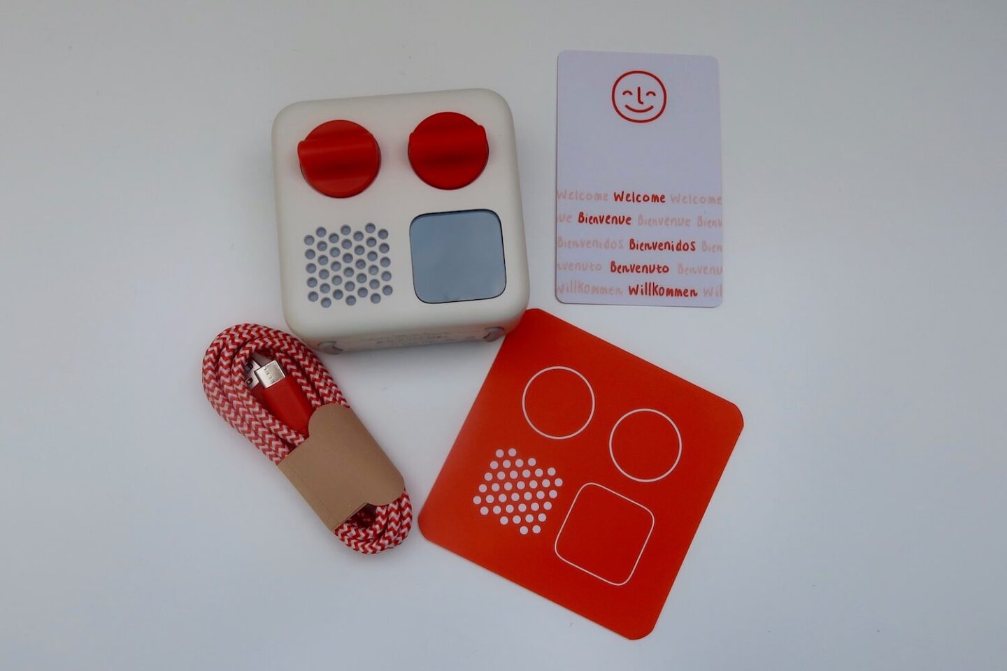 The contents of a Yoto player box. There is the Yoto, welcome card, charger and instructions