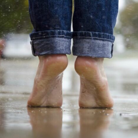 Someone standing in bare feet in the rain