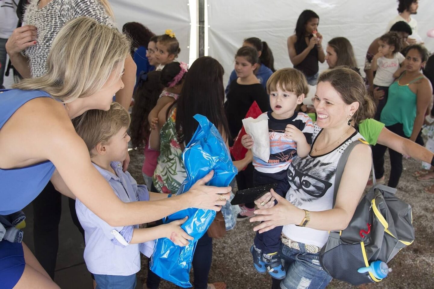 A large community event with a lot of people and children together