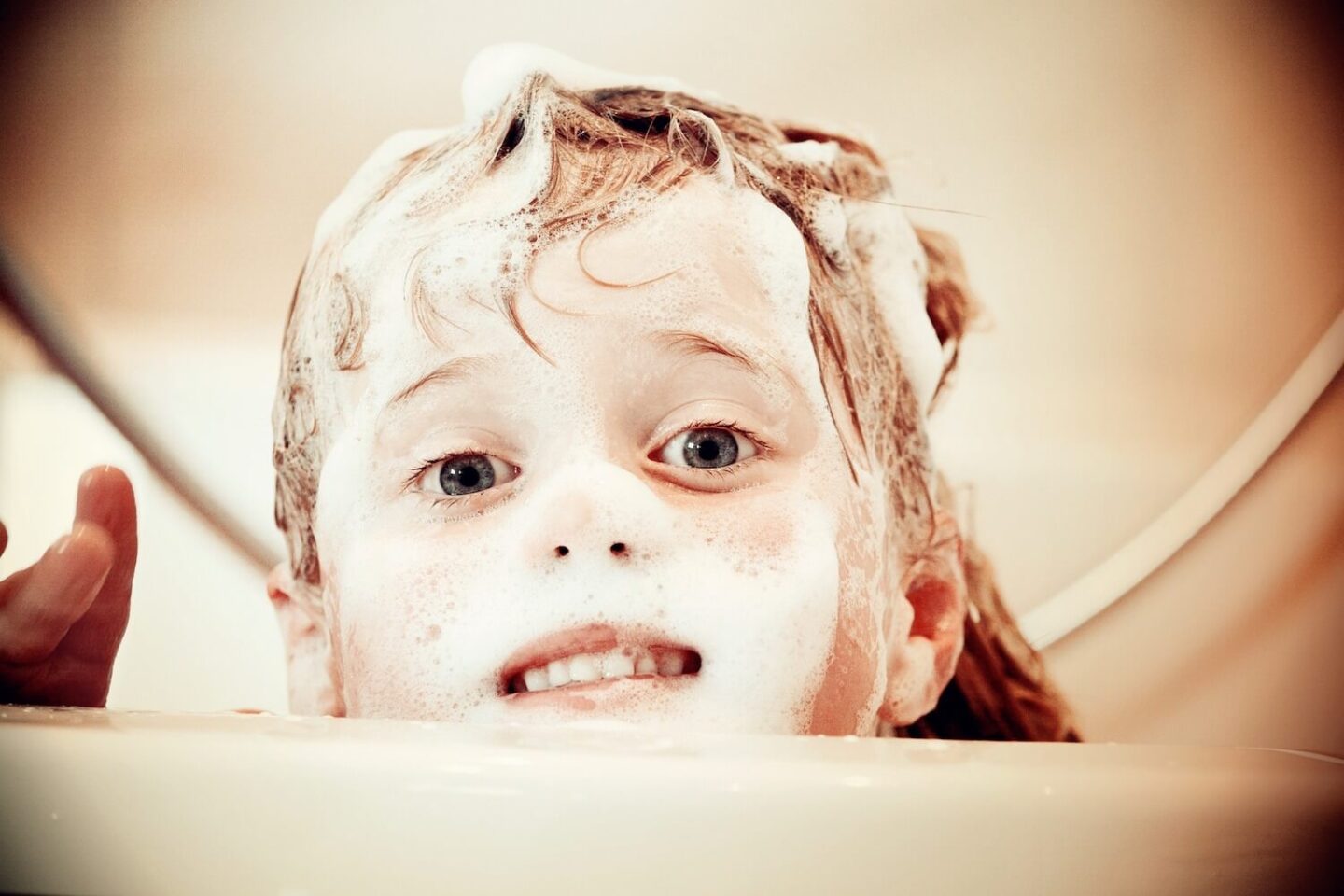 A child covered in soap from the bath