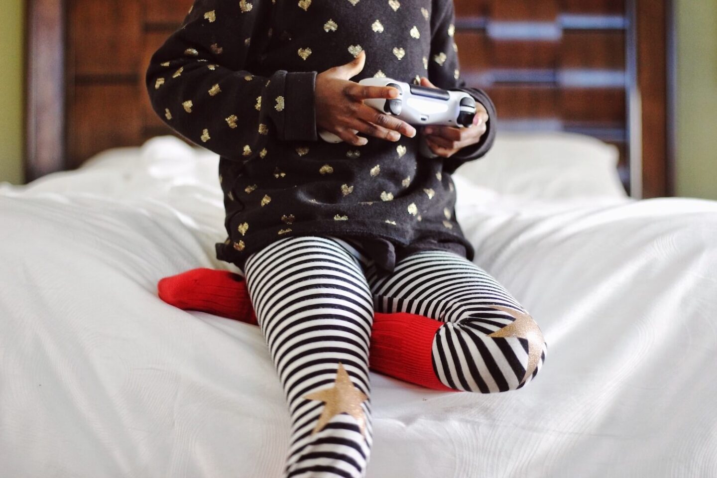 The torso of a child holding a games console controller