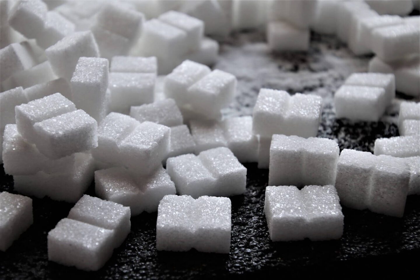 Sugar cubes on a black surface