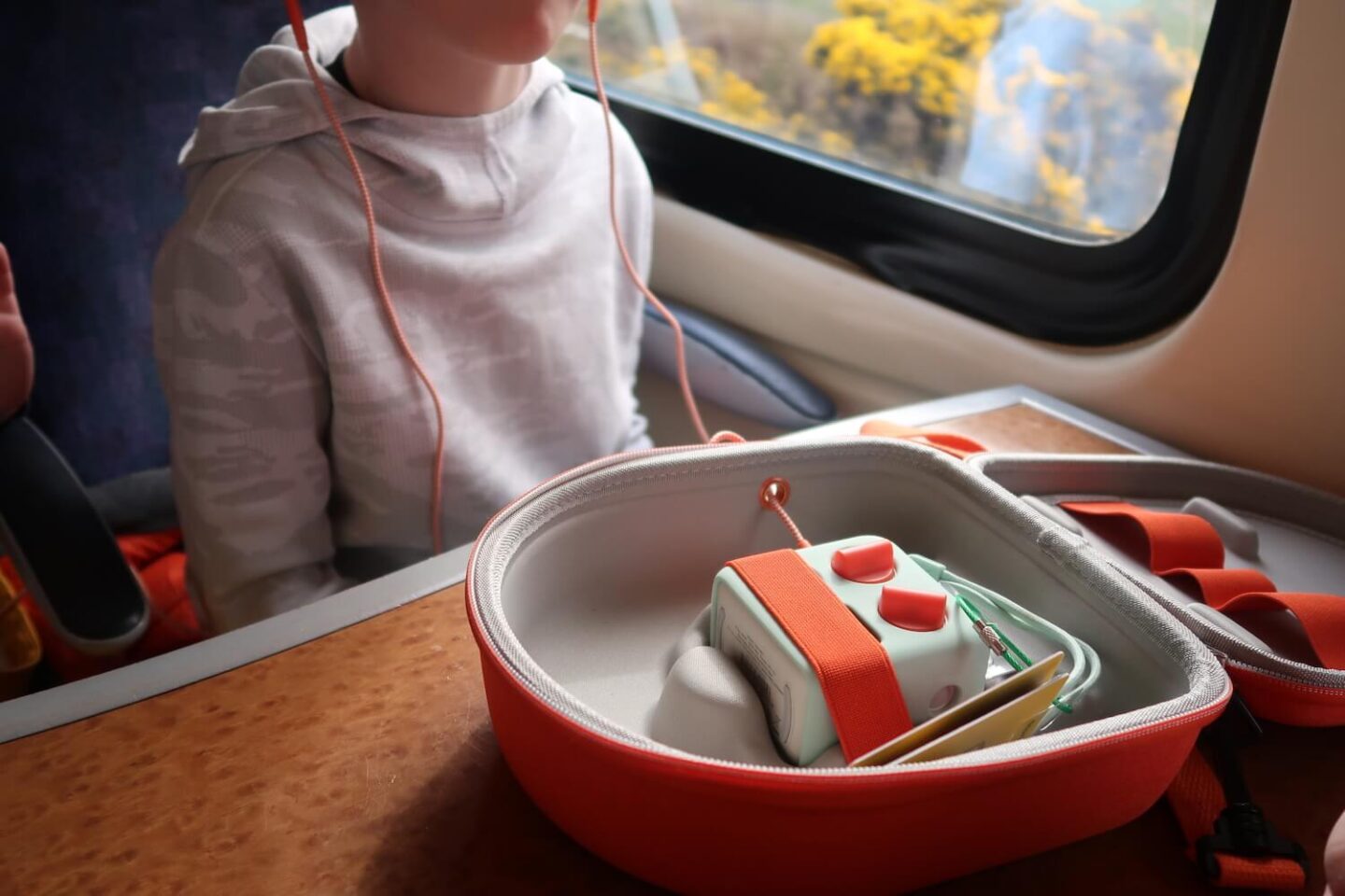 A yoto mini travel case open on a train table