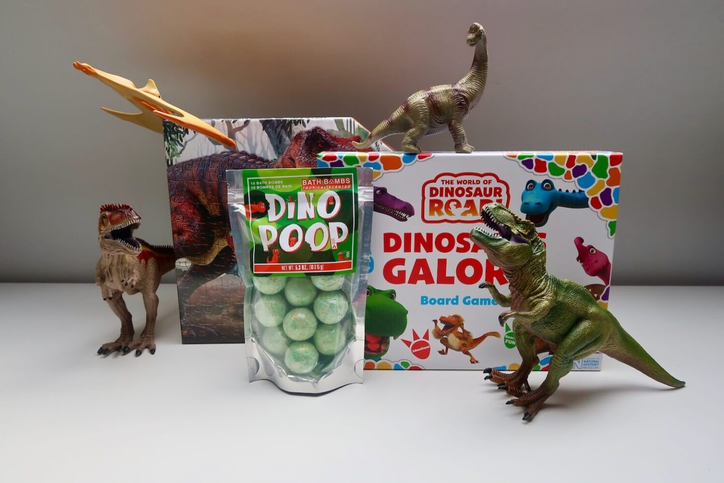 Dinosaur themed games and toys surrounded by plastic dinosaurs