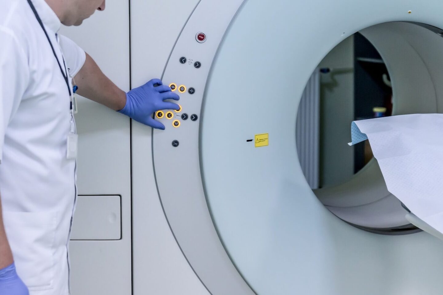 An MRI machine with the technicians pressing a button 