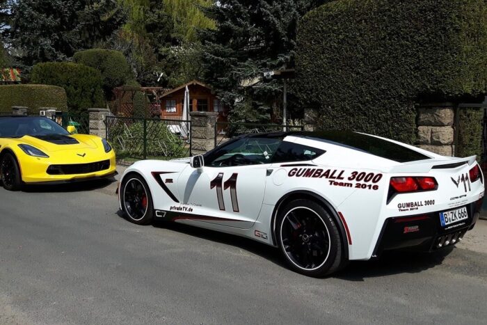 2 Corvette's parked on the street